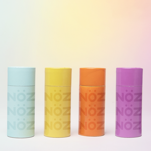 Noz vegan sunscreen available in four different colors: blue, yellow, orange, and purple.